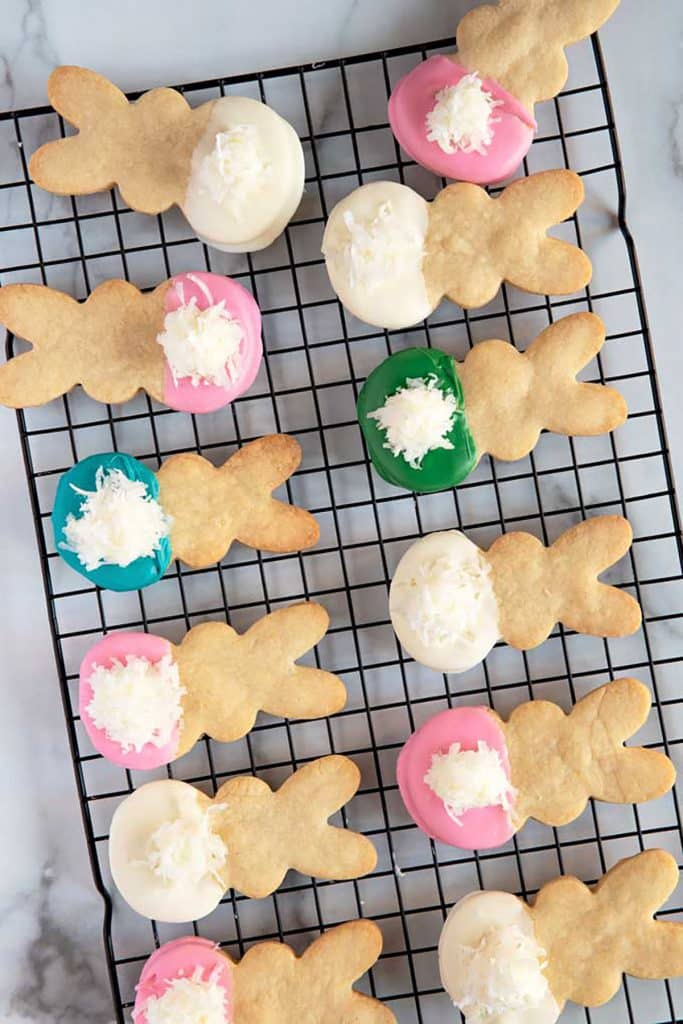 top view of twelve easter bunny cookies over a cooling rack