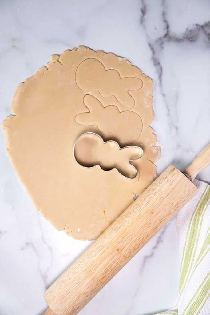 cutting the dough with a bunny shaped cookie cutter