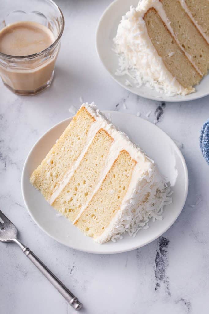 slice of white coconut cake on its side on plate