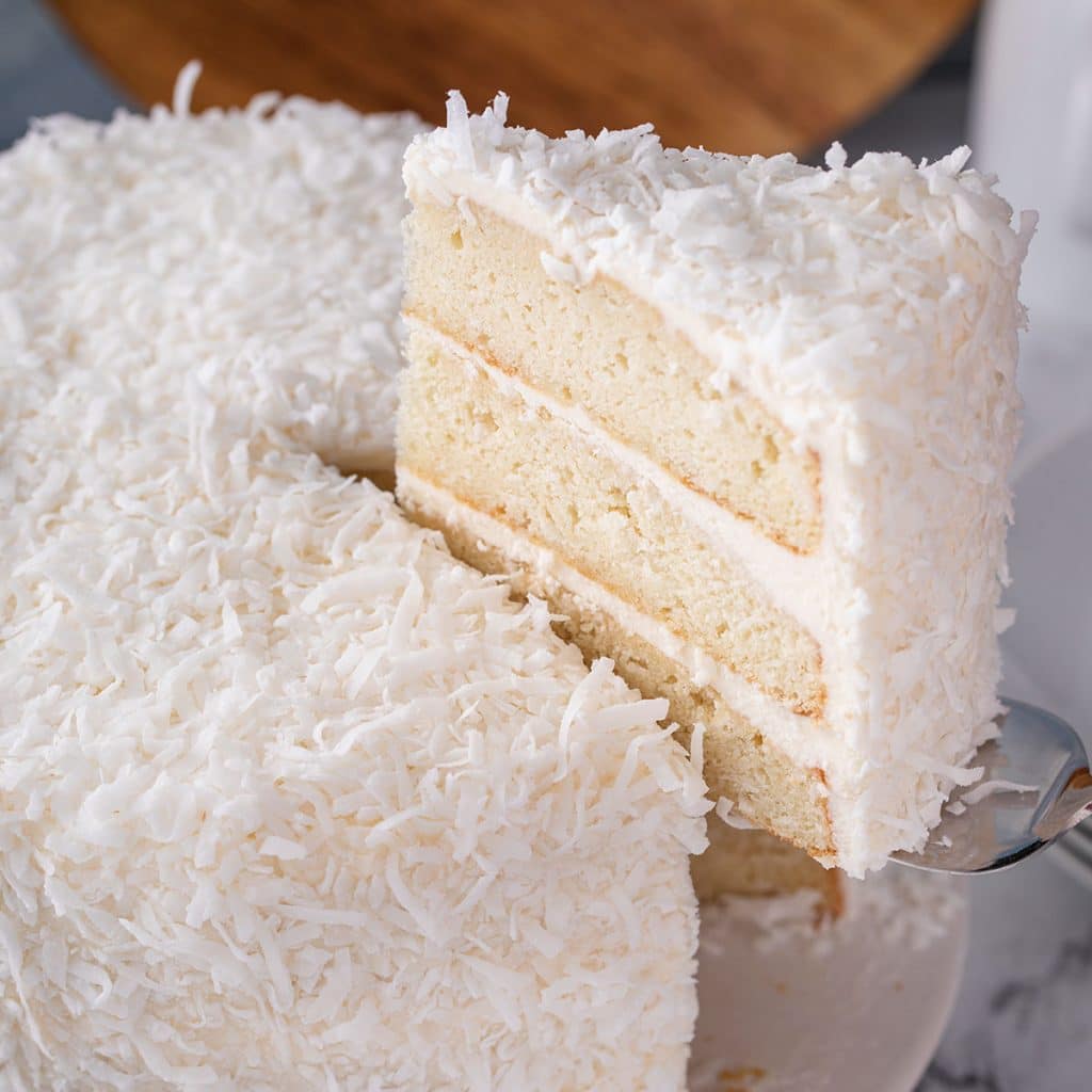 slice of coconut cake being served