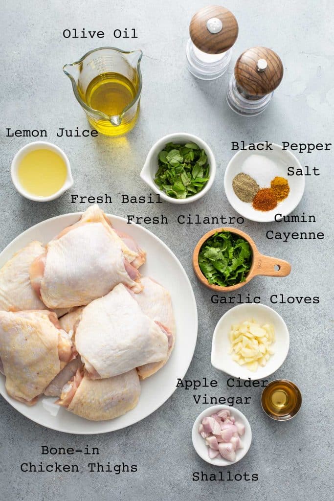 Ingredients needed to make lemon and herb skin-on chicken thighs.in the oven