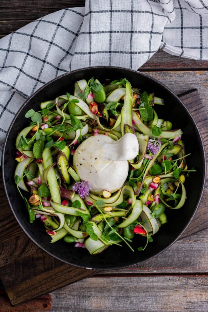 Raw Shaved asparagus salad with burrata cheese.