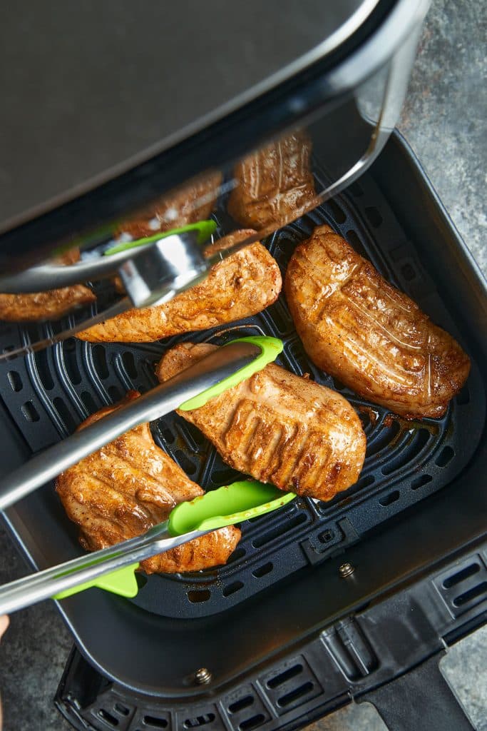 pork chops in air fryer with tongs