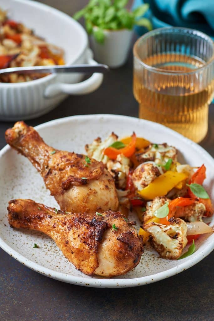 Two chicken legs served with veggies