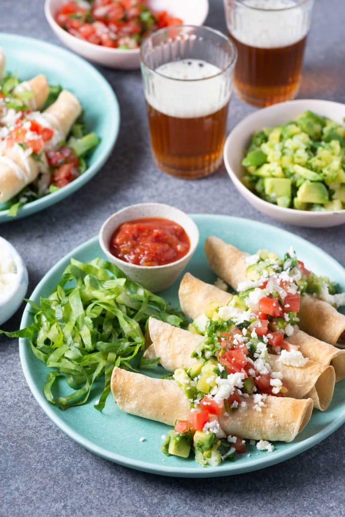 Crispy taquitos topped with crumbled cheese, avocado, tomatoes and served with shredded lettuce and salsa.