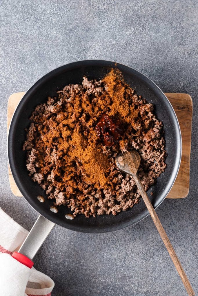 Browned ground beef with taco seasoning in a skillet