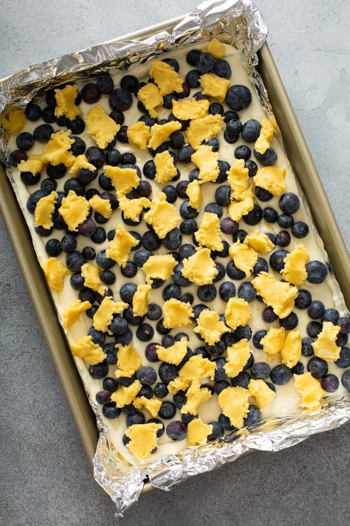 blueberries and small pieces of the remaining cake mixture over the cheesecake filling