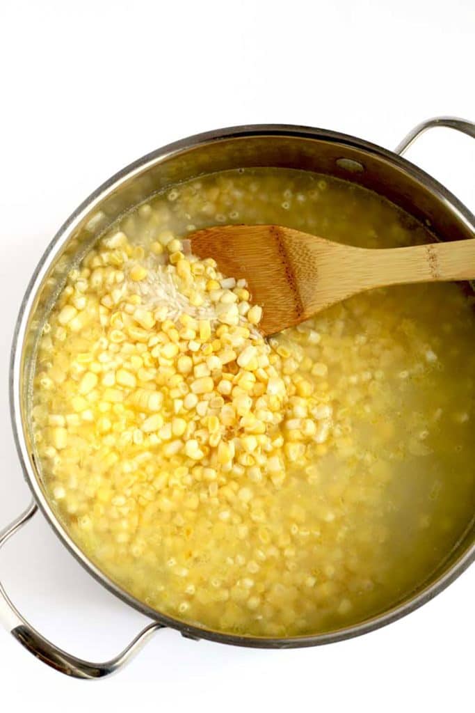cooking rice with corn in a pot