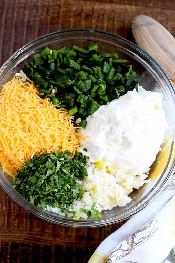 sour cream, chopped poblano pepper, cilantro, cooked rice and sharp cheddar cheese in a large bowl.