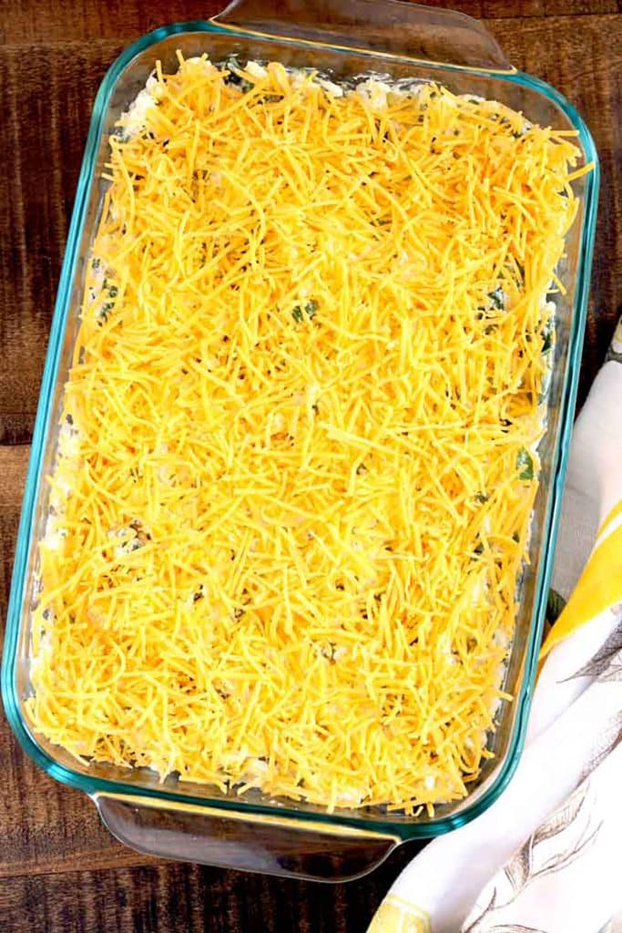 green chile rice in a casserole with shredded cheese on top