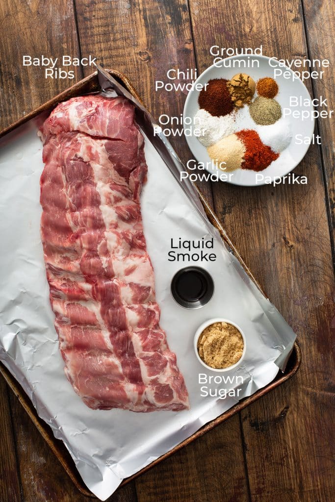 ingredients to make pork ribs on a wooden board