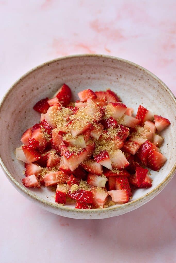 brown sugar over chopped strawberries