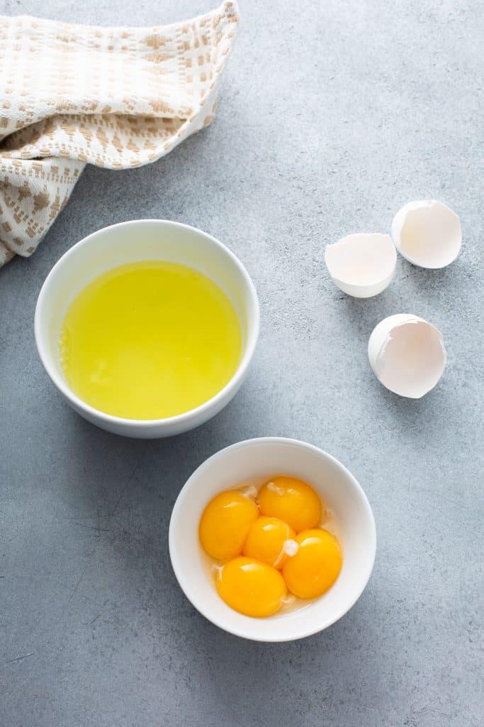 Egg whites and egg yolks in separate small bowls
