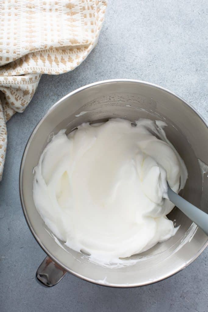 Whipped egg whites in a mixing bowl