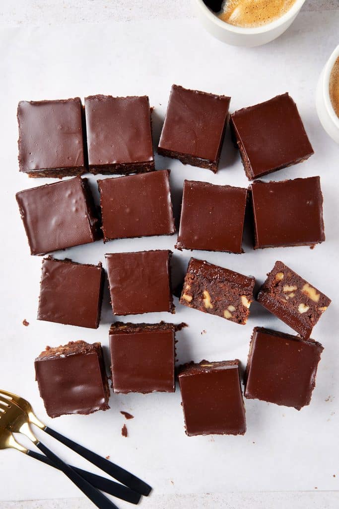 brownies covered with smooth and shiny chocolate cut up into pieces