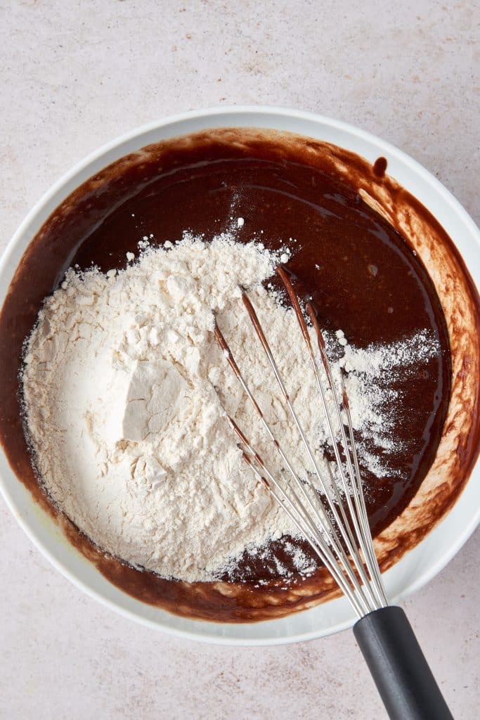Chocolate mixture with flour in a white bowl.