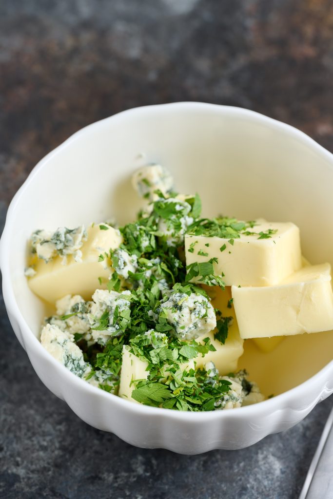 Butter, chopped parsley and blue cheese in a small bowl.