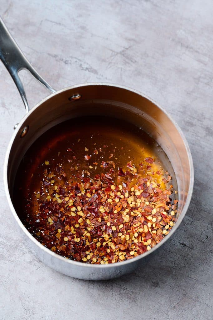 honey, chili flakes and chili powder in a small saucepan