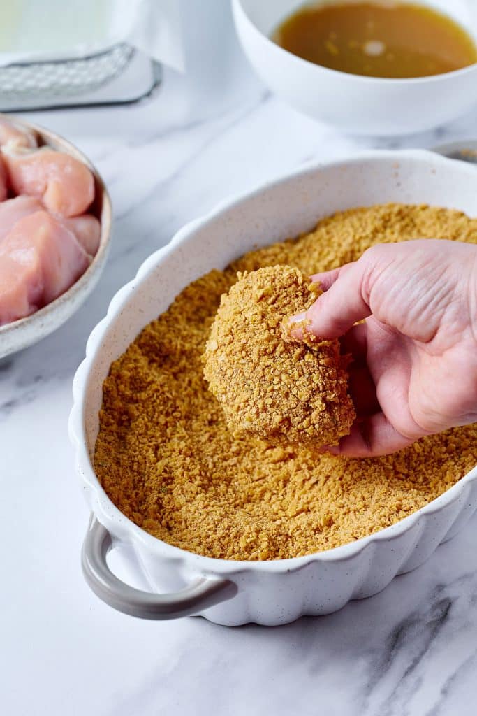 dredging chicken for second coating of crumb mixture