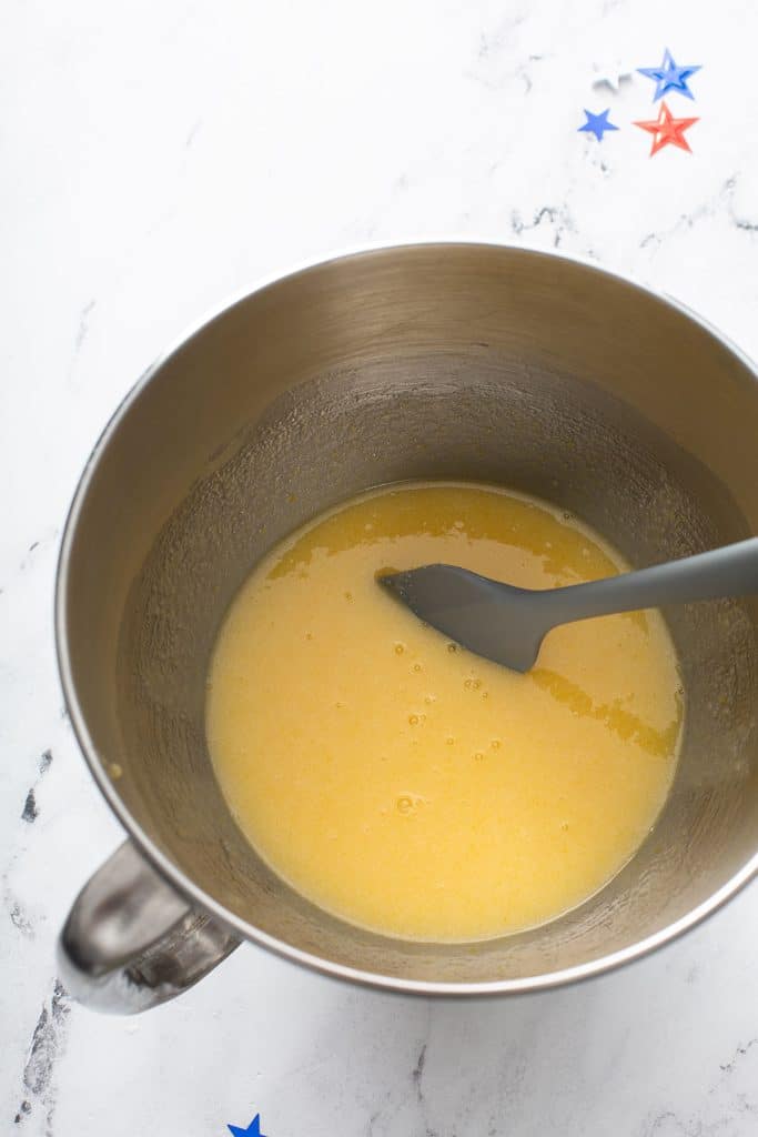 Sugar, oil and eggs combined in the bowl of a stand mixer