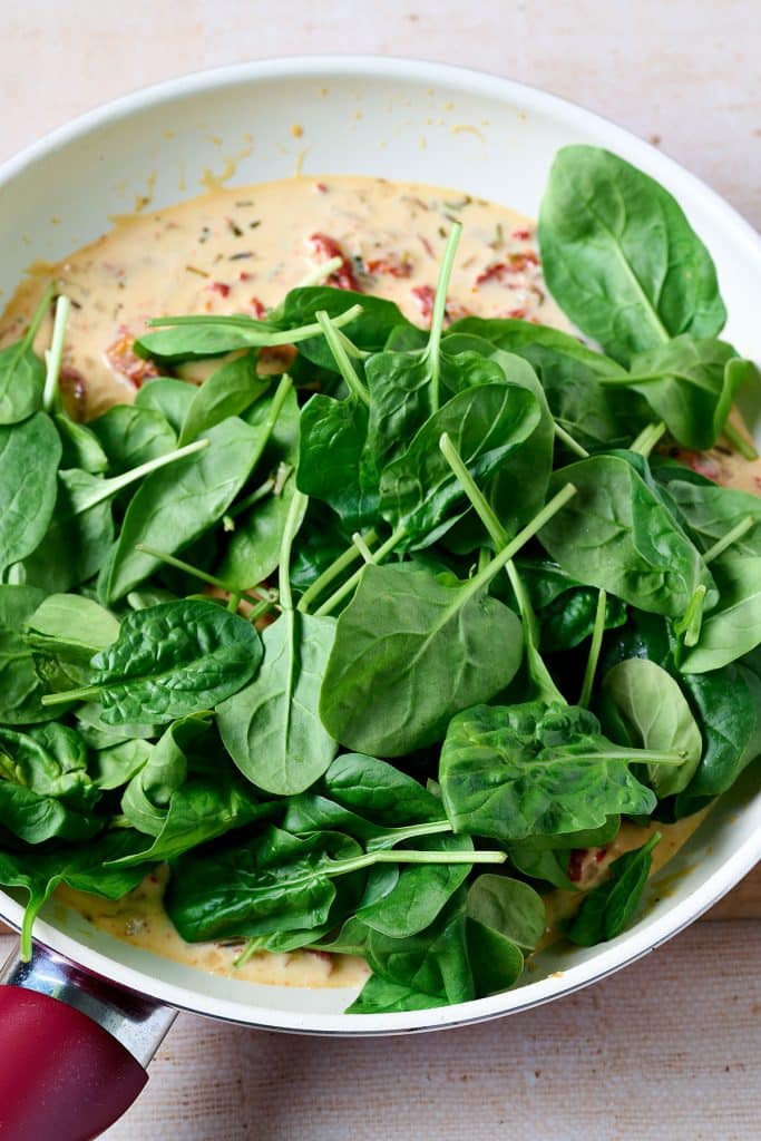 baby spinach over the tuscan sauce