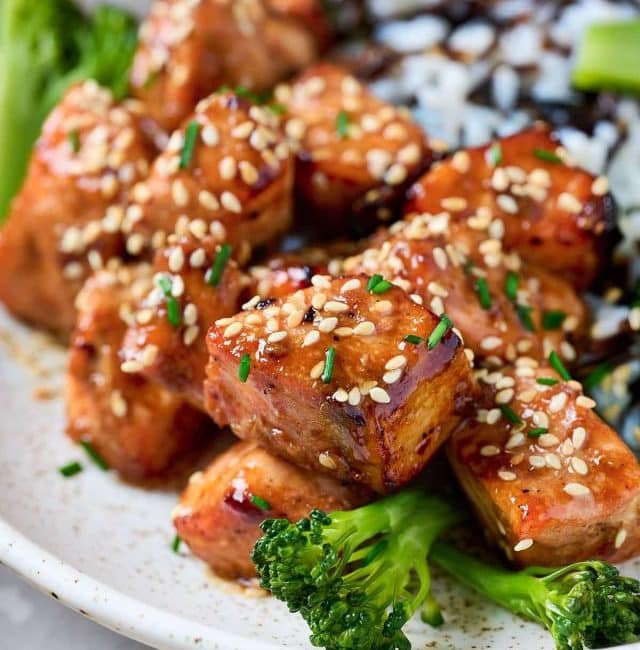 Golden brown sticky salmon bites with sesame seeds.