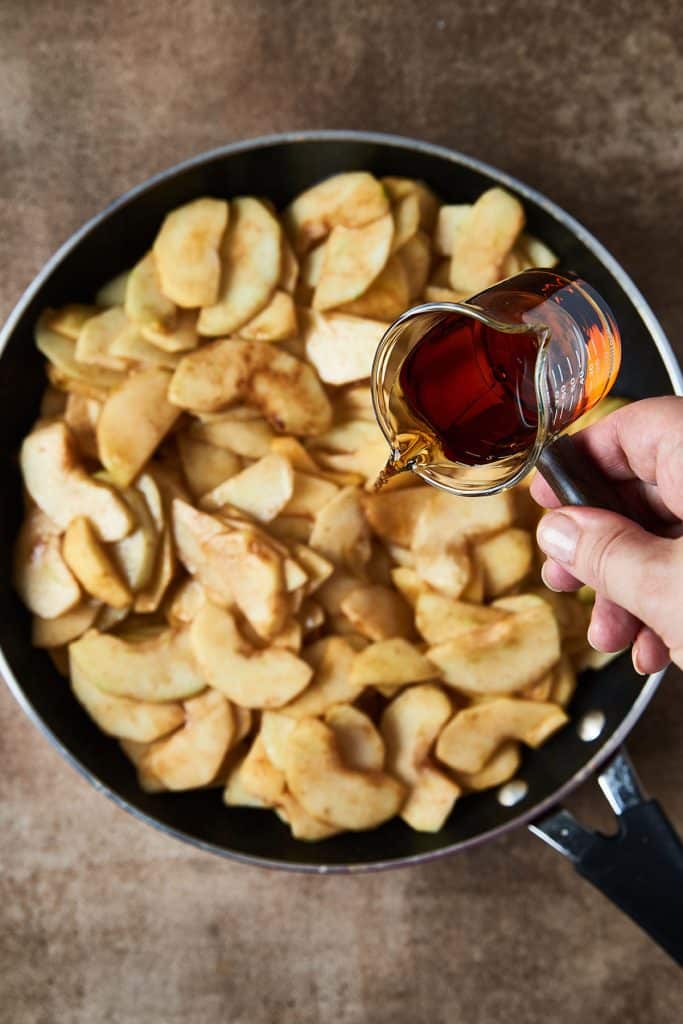 pouring bourbon over apple slices