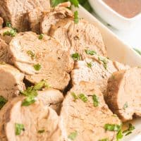 Close up view of pieces of Pork Tenderloin on a white serving plate