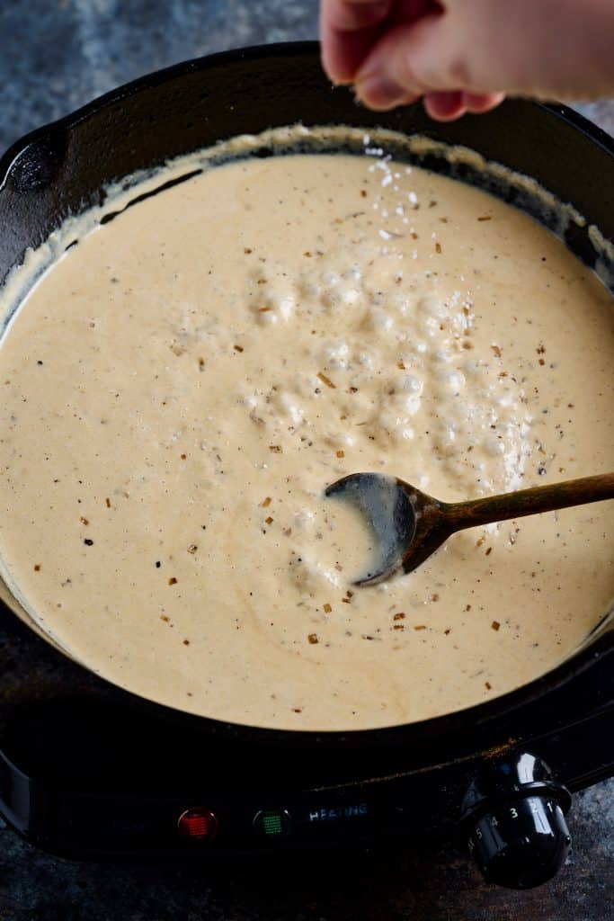 Finishing the creamy peppered sauce to serve with steak