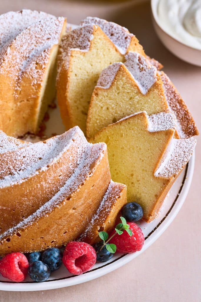 Close up of sliced bundt cake dusted with sugar