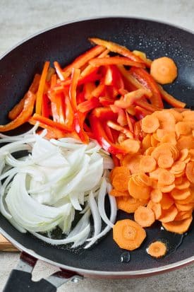 carrots, bell peppers and onions on a pan