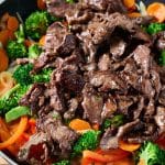 adding the seared steak to the cooked veggies