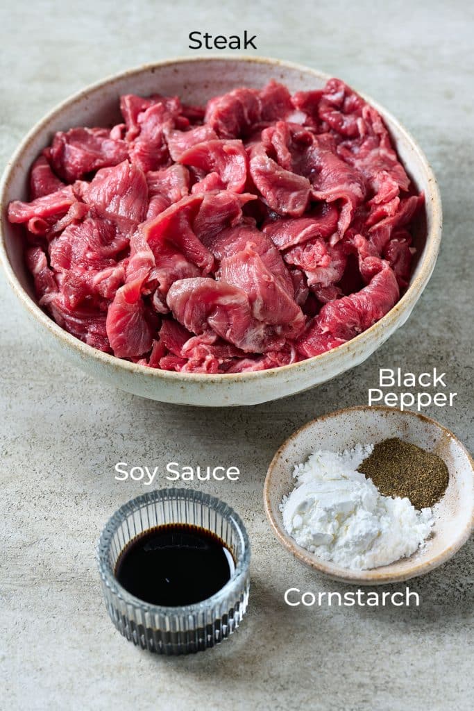 sliced steak with marinade ingredients.