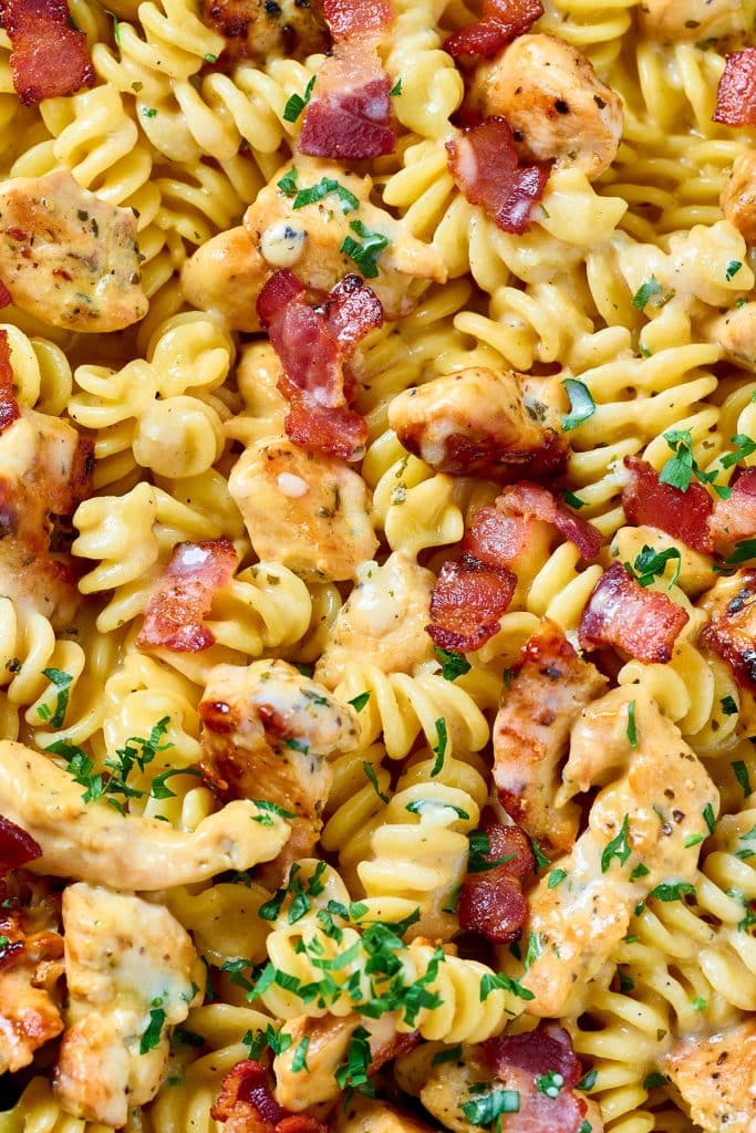 Close up view of. acreamy pasta with chicken breast pieces and crispy bacon