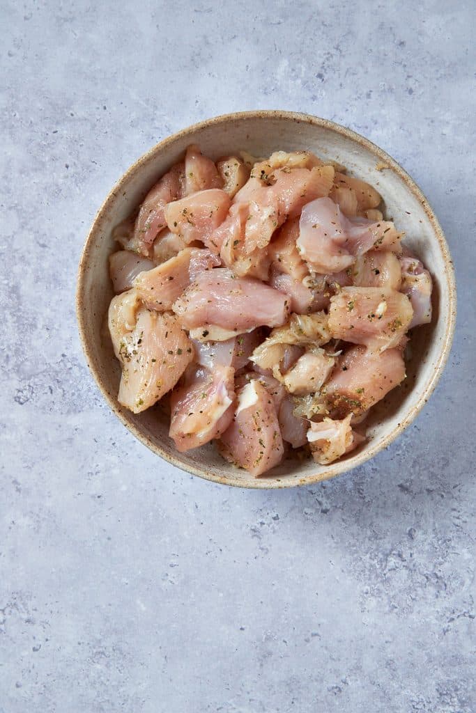 Seasoned chicken breast pieces in a bowl