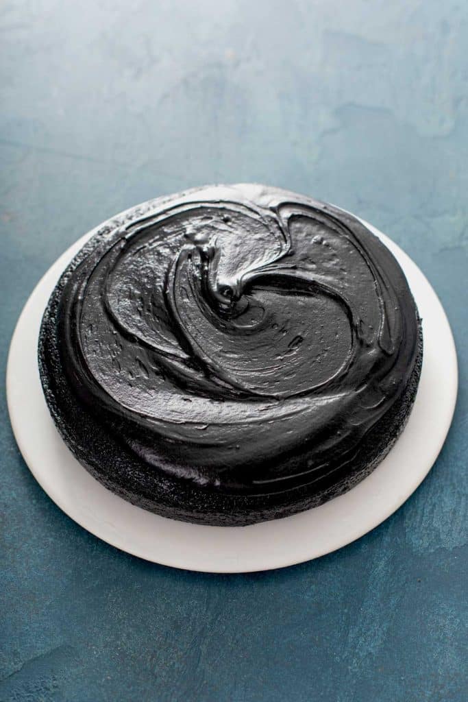 black frosting over one of the cakes