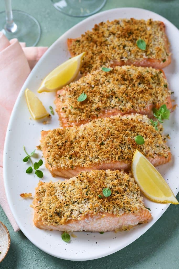 Crispy Panko salmon with lemon wedges served on a platter.