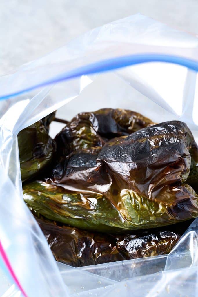 Roasted poblanos in a resealable plastic bag.