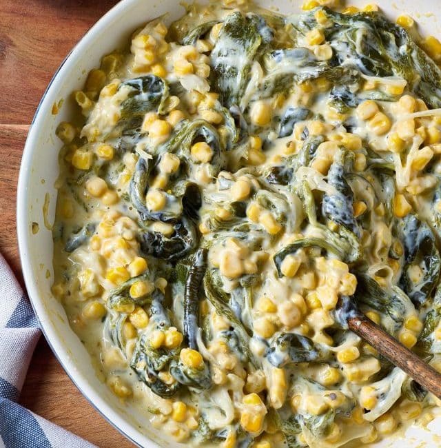 A bowl with creamy rajas (roasted poblano peppers) and corn in a creamy white sauce