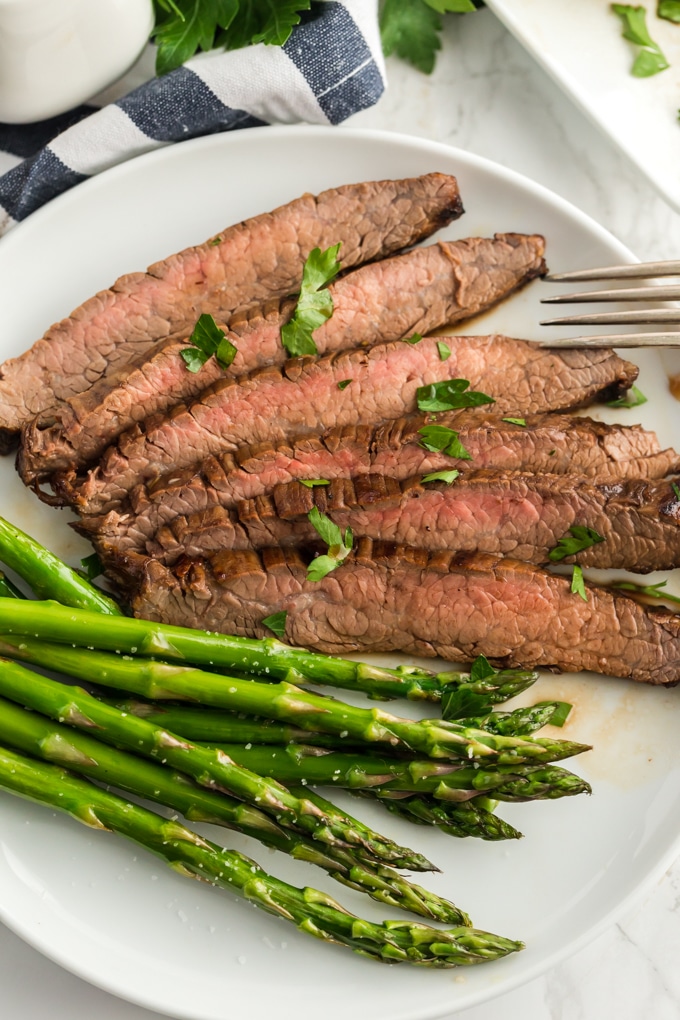 Thin slices of steak served with asparagus.