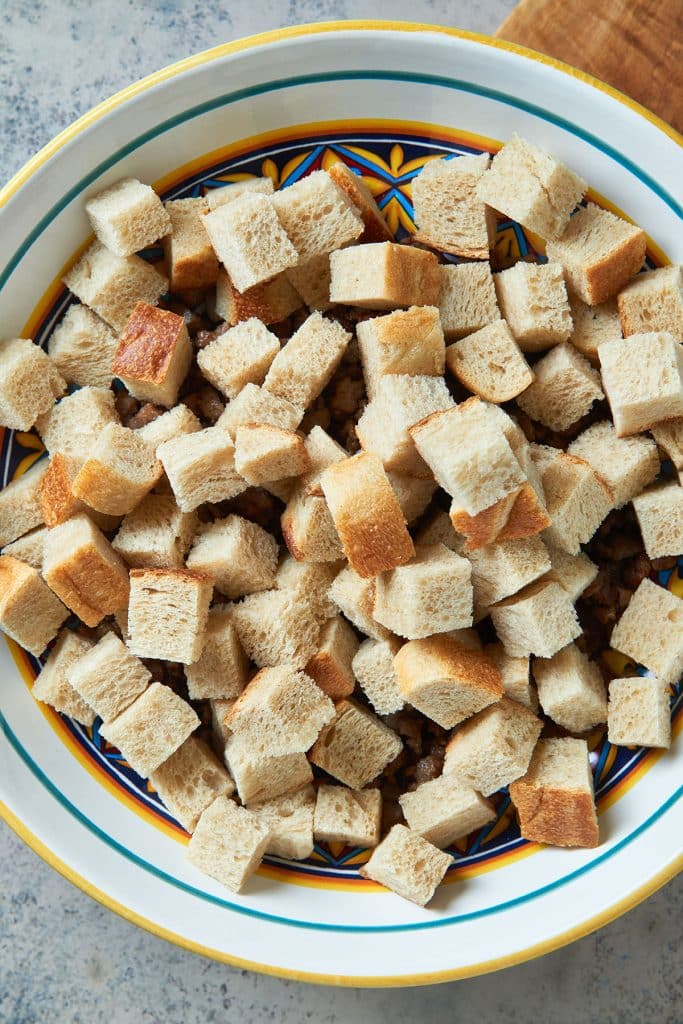 bread cubes on a bowl (over the cooked sausage)