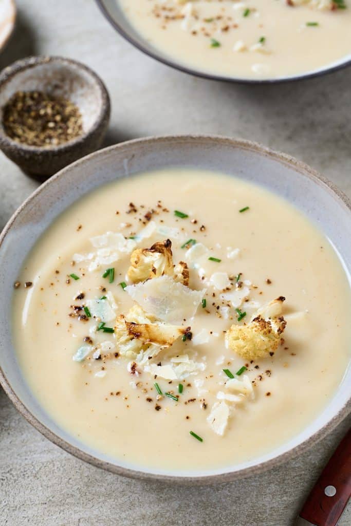 Creamy cauliflower soup served in a soup bowl.