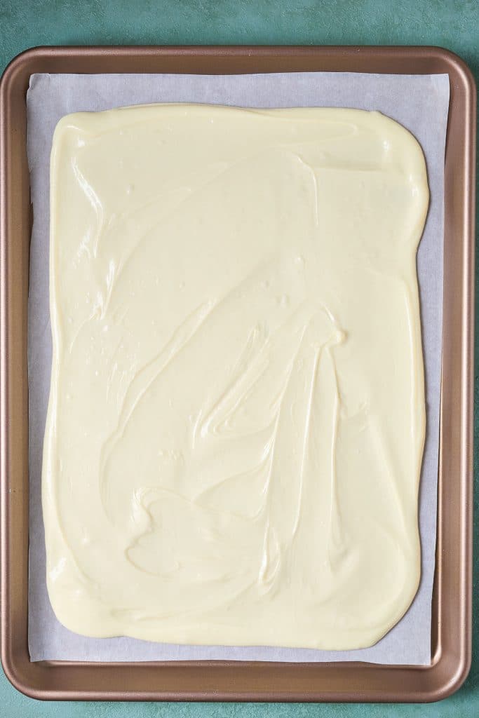 A layer of white chocolate on a baking pan.