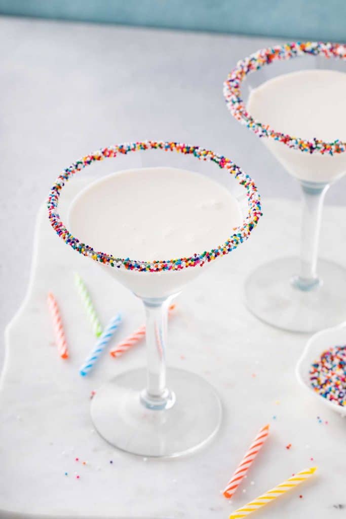 A couple of birthday cake martini dipped in rainbow sprinkles.