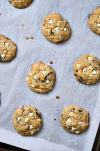 Baked cookies on a parchment paper lined cookie sheet.