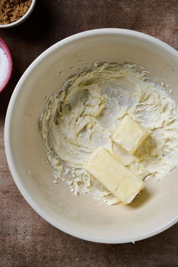 Creamed cream cheese and softened butter in a bowl.
