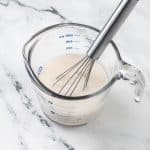 almond milk and vinegar in a measuring cup