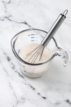 almond milk and vinegar in a measuring cup