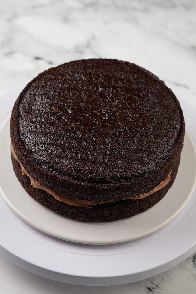 two chocolate cake disks assembled with chocolate frosting in the middle