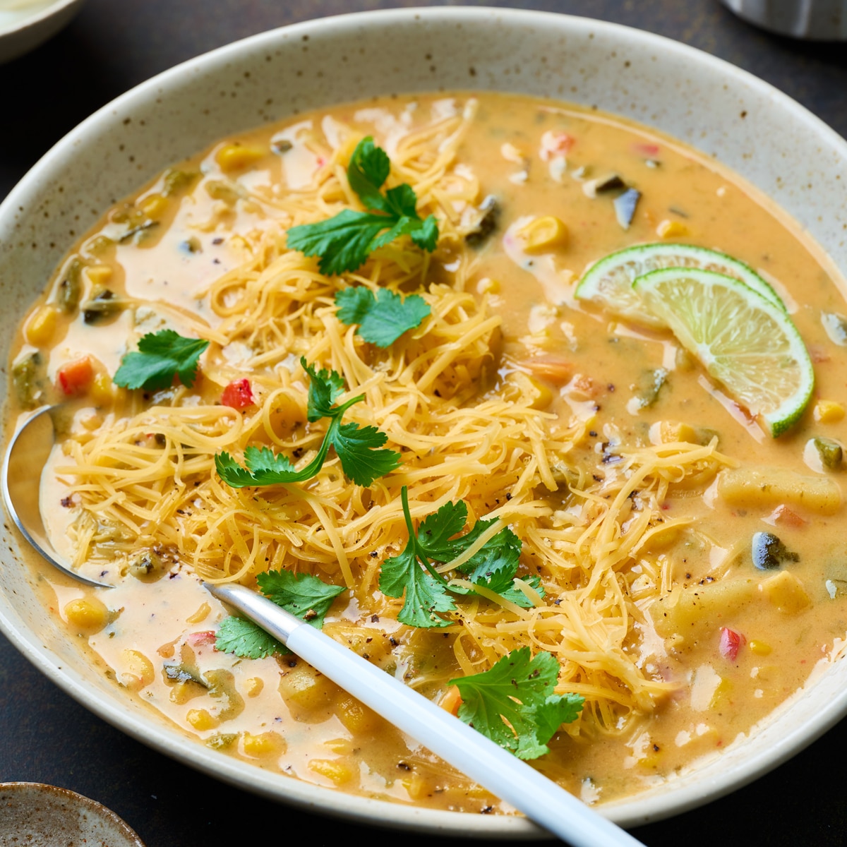 roasted poblano corn chowder granished with cilantro served in a bowl
